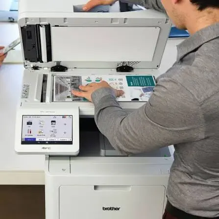User scanning a color document on a Brother multifunction system